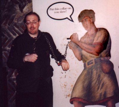 Some bloke in skirt tries to get Shimmer to join some bondage fun