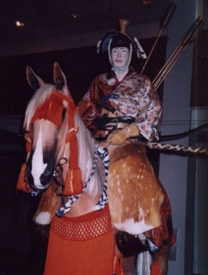 A deadly but slightly camp looking warrior with show-off arrows and an interesting taste in headgear.